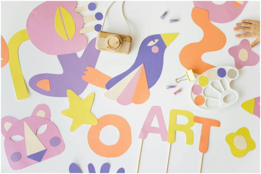 Vibrant flatlay of colorful paper cutouts and art