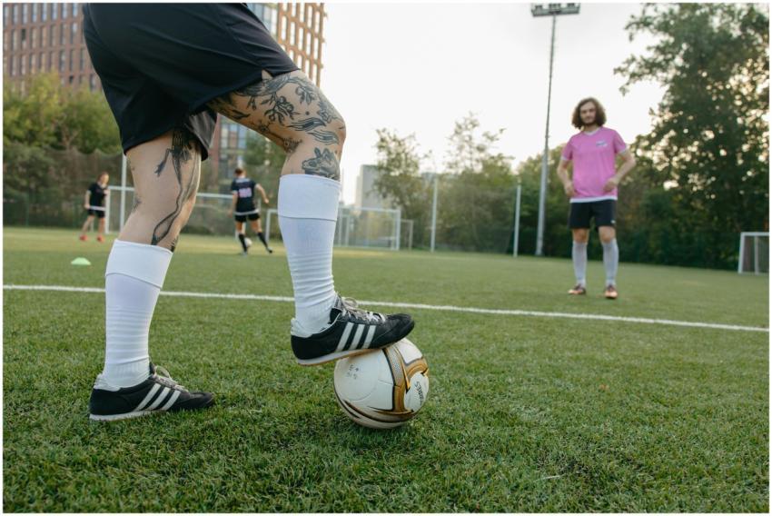 Close-up of a soccer player with tattoos controlli