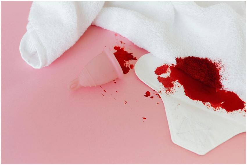 Menstrual cup and sanitary pad with blood stains o