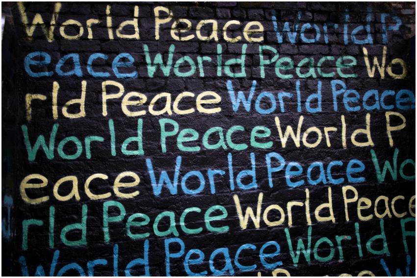 Colorful graffiti on a brick wall repeating the ph