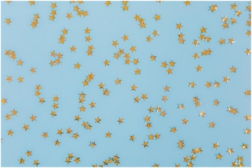 Gold star confetti scattered over a light blue sur