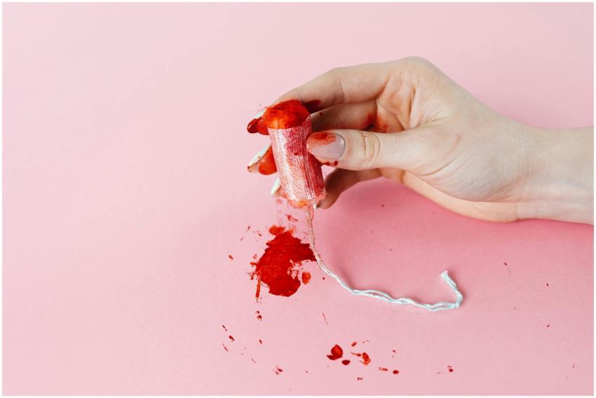 Conceptual image of menstruation showing a hand ho