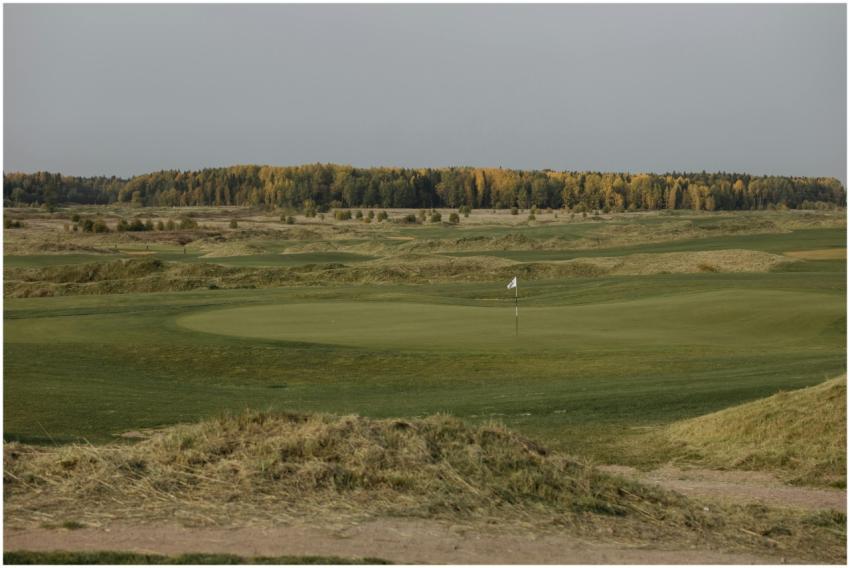 Beautiful golf course in fall with a flag on the g