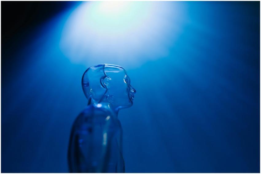 Transparent robotic figure illuminated by blue lig