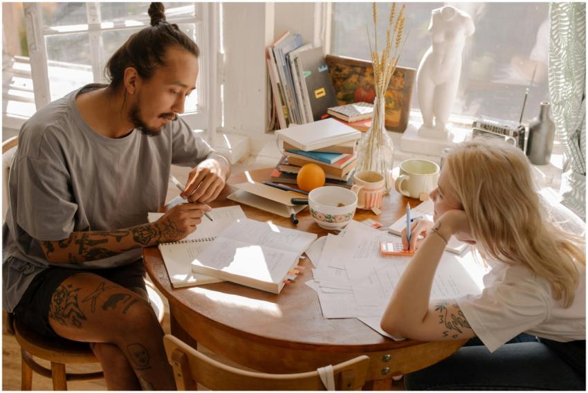 Two students studying with books and notes, collab
