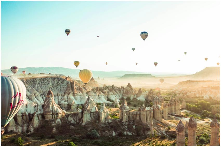 A stunning aerial view of hot air balloons floatin