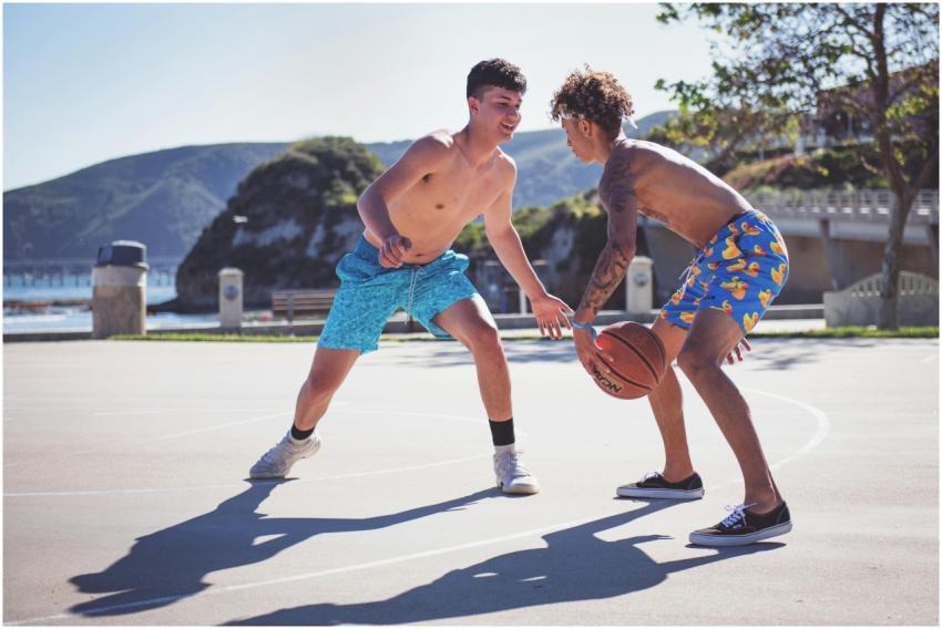 Two young men enjoying a competitive basketball ga