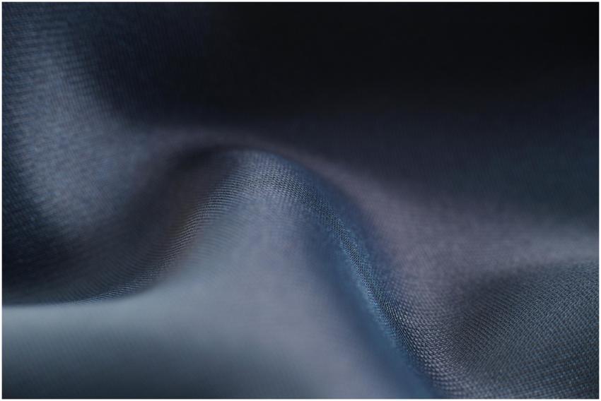 Close-up view of blue fabric showcasing smooth tex