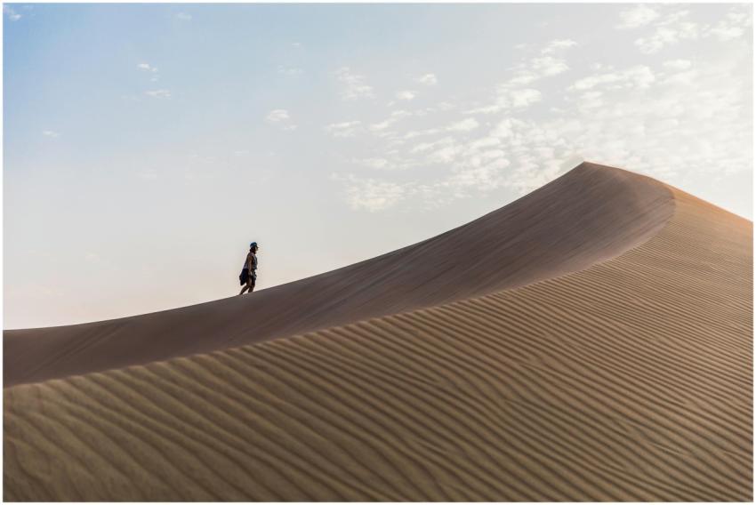 A lone traveler explores the majestic sand dunes o