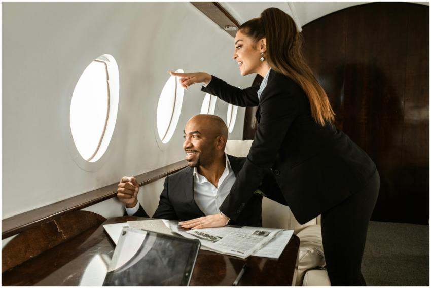 Smiling couple in a private jet, enjoying the view