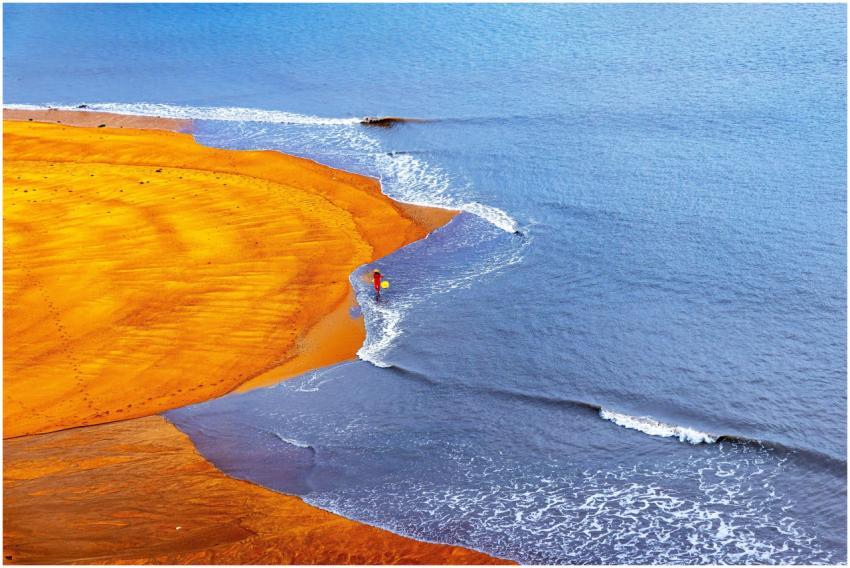 A dynamic aerial view of a person walking along a