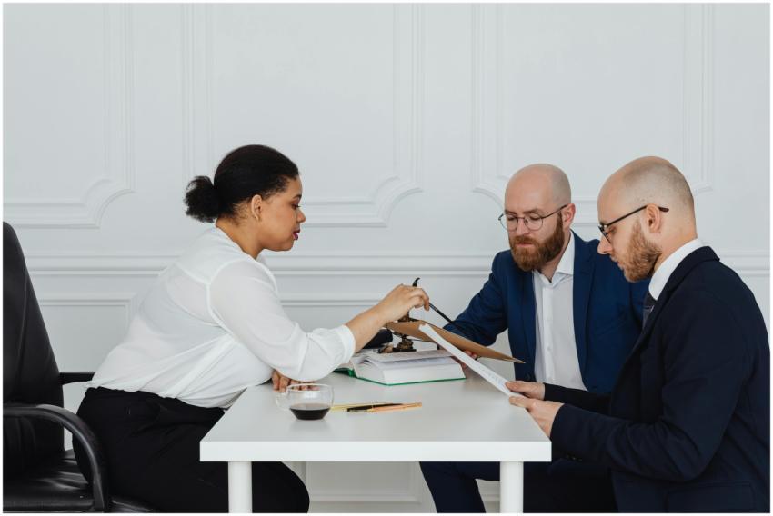 Business team discussing documents around table in