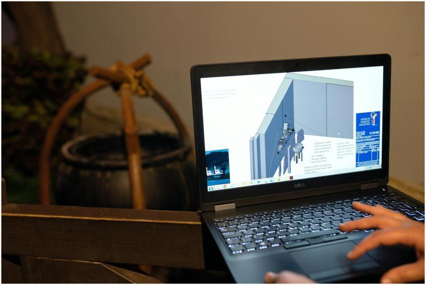 Engineer working on a CAD design using a laptop co