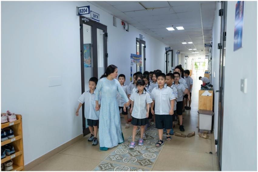 Teacher guiding students in uniform through school