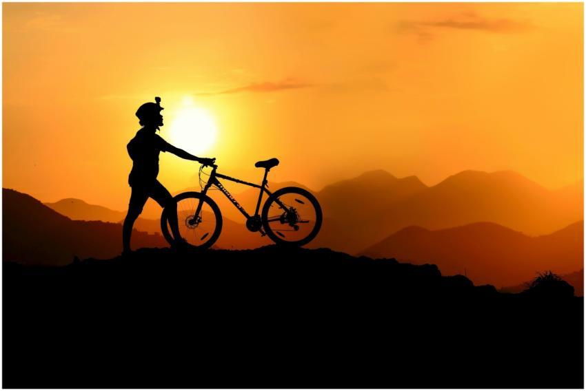 Silhouette of a mountain biker at sunset, showcasi