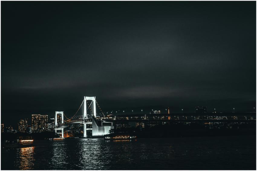 Stunning view of Tokyo's Rainbow Bridge at night,