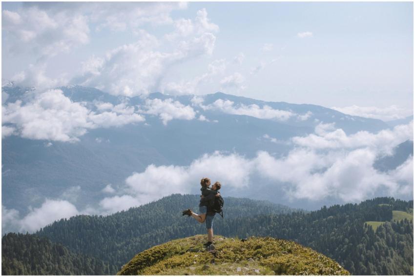 A couple enjoys a breathtaking view from a mountai