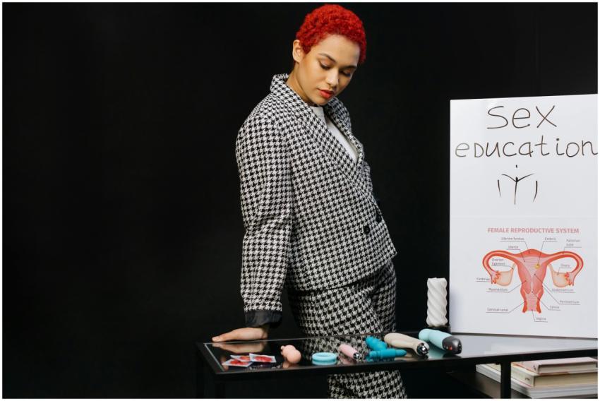 A woman in formal attire conducting a sex educatio