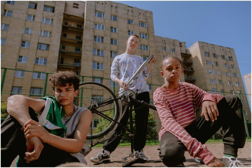 Teen boys hanging out with a bicycle in an urban a