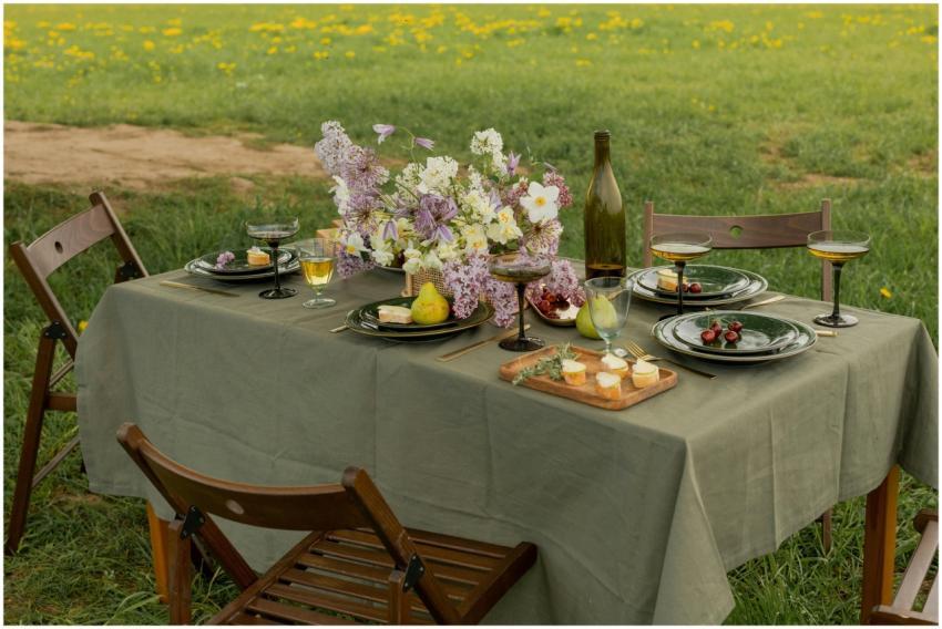 Elegant picnic table set with flowers and glasswar