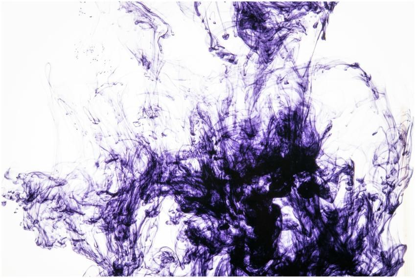 Captivating abstract image of purple ink flowing a