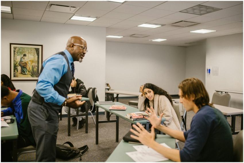 A professor interacts with college students during