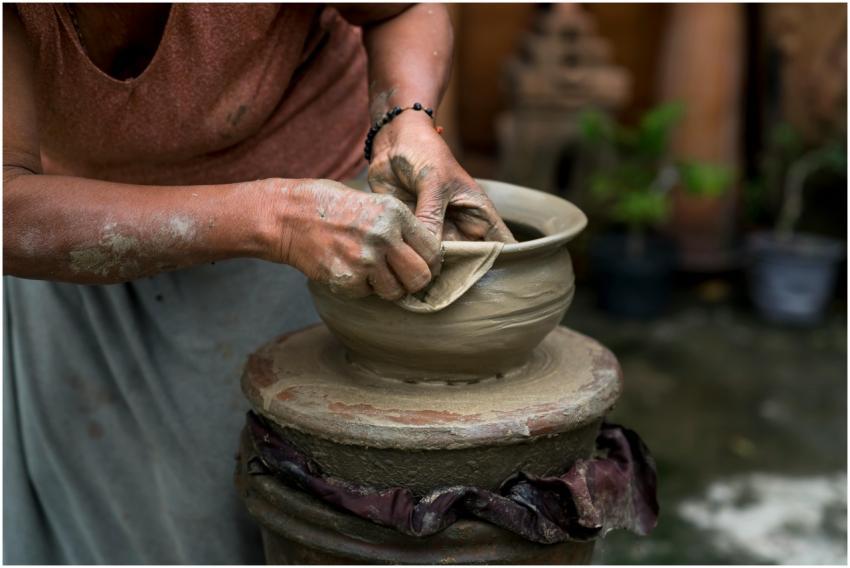 A skilled potter shaping clay on a wheel, showcasi