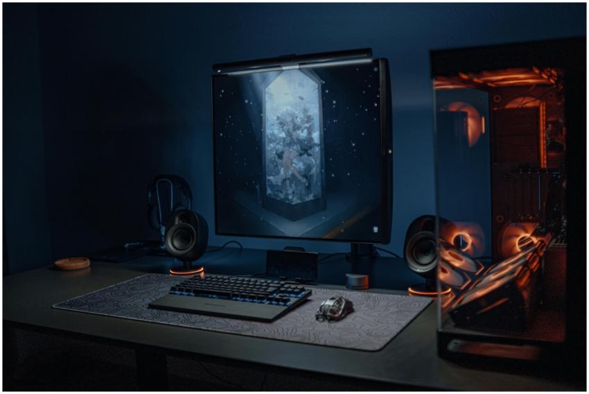 A stylish gaming setup featuring a screen, keyboar