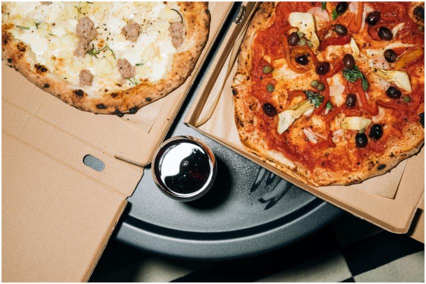 Top view of delicious pizzas in boxes with a refre