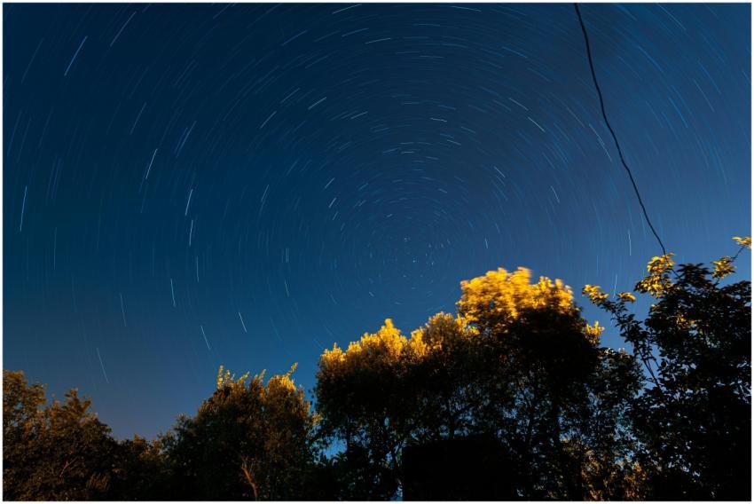 Long exposure of night sky with star trails over s