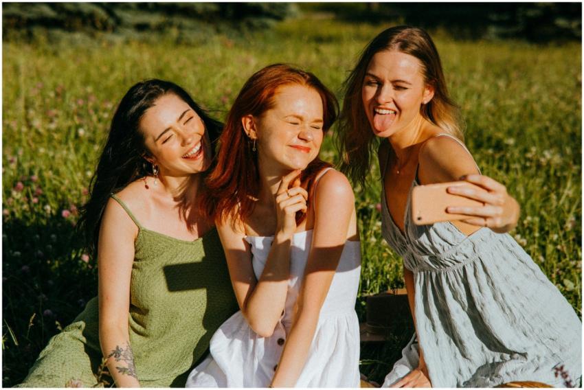 Three young women enjoying a cheerful selfie outdo