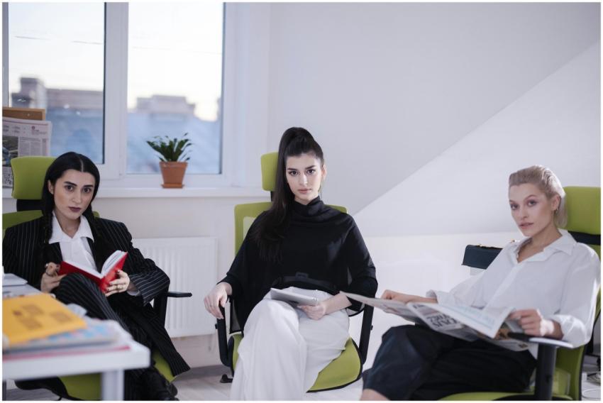 Three women professionals sitting in a modern offi