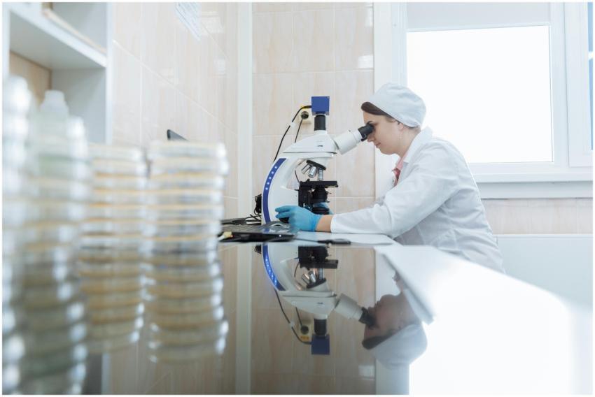 Female scientist using a microscope in a laborator