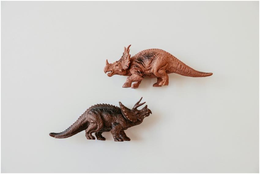 Two detailed dinosaur toy models, including a Tric