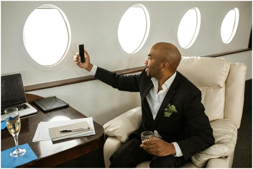 A businessman enjoying a drink and video call in a