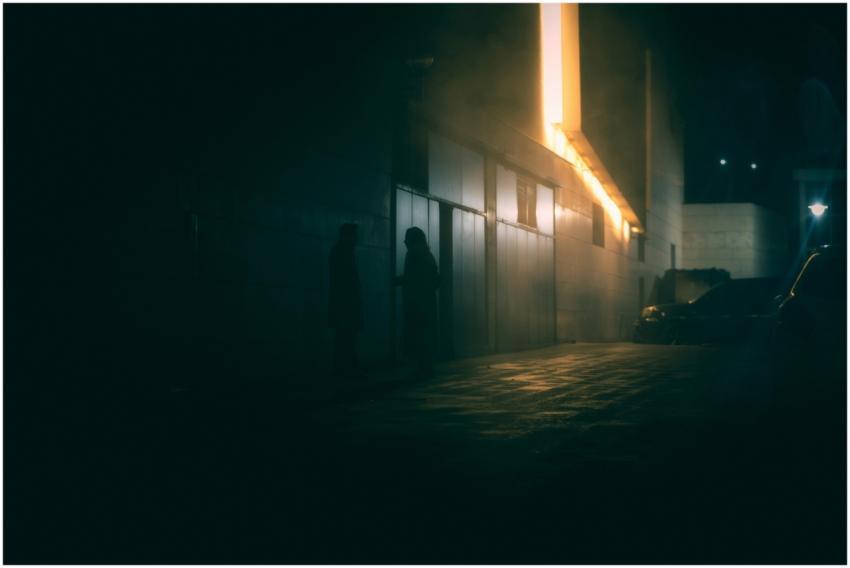 Eerie silhouettes in a foggy alleyway in Ankara, c