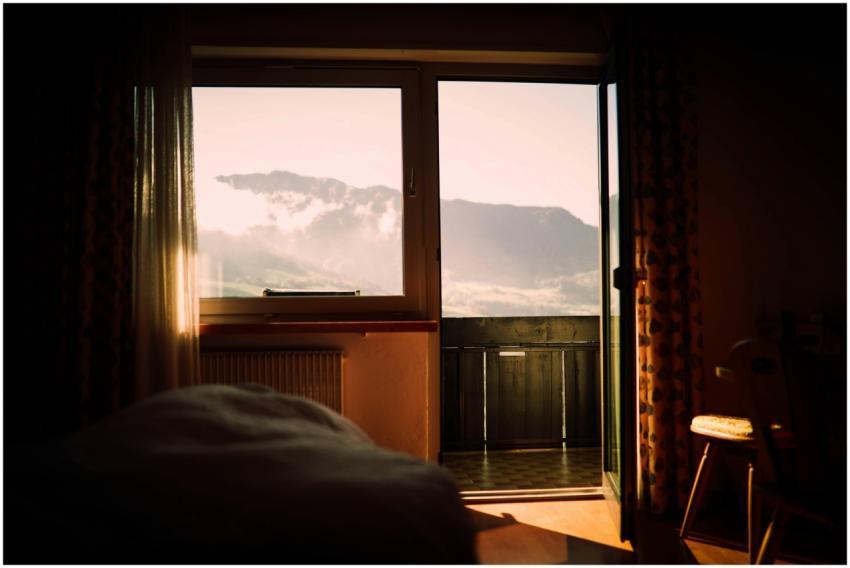 A cozy bedroom with a stunning mountain view throu