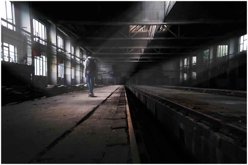 A lone skater navigates through a sunlit abandoned