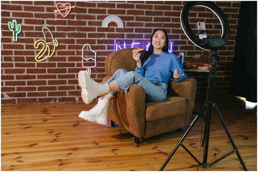 Young Asian woman influencer streaming live video