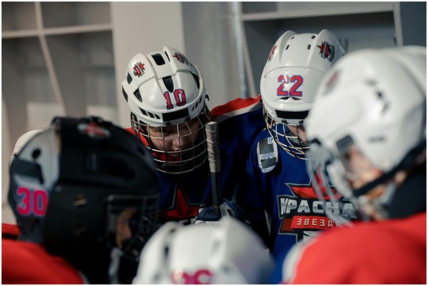 Teen hockey players in locker room getting ready,
