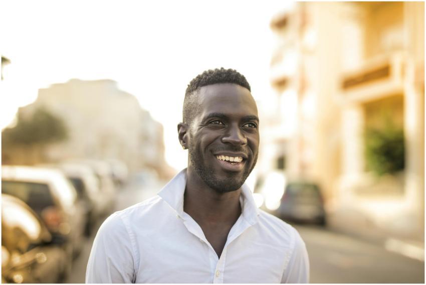 Portrait of a cheerful man outdoors in a city sett