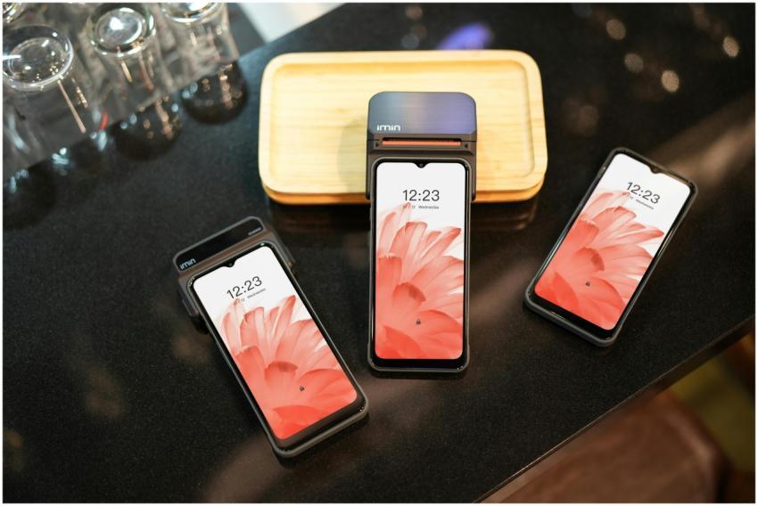 Close-up of three modern smartphones displaying a