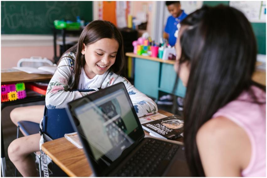 Children engaged in learning with a laptop in a vi