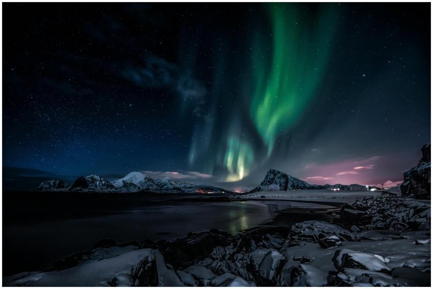 Stunning view of aurora borealis over snow-capped