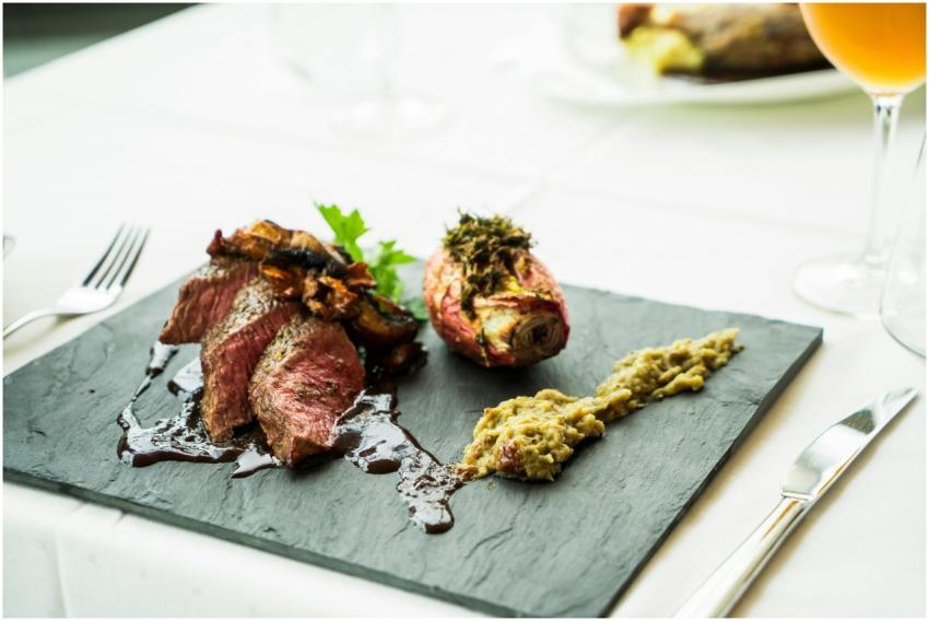 Deliciously plated steak with sauce and sides, ser