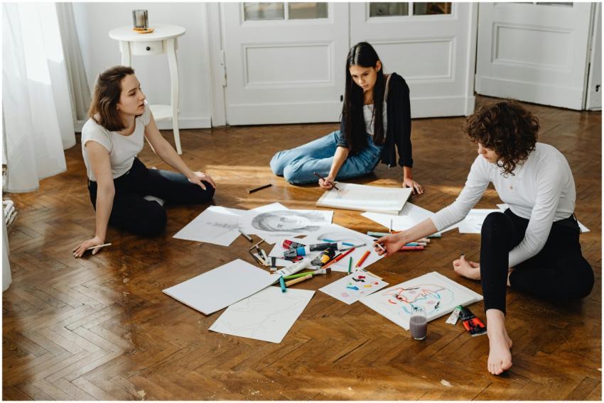 Three women engage in a creative drawing session o