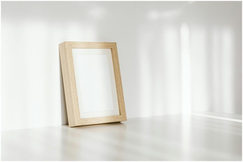A close-up of an empty wooden photo frame leaning