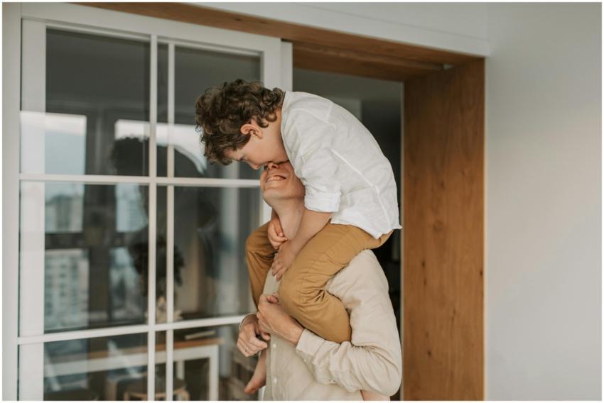 A joyful moment of a father carrying his son on hi