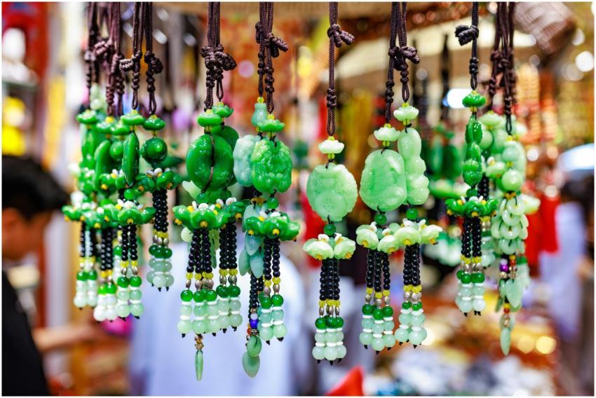 Vibrant green jade ornaments hang in a busy market