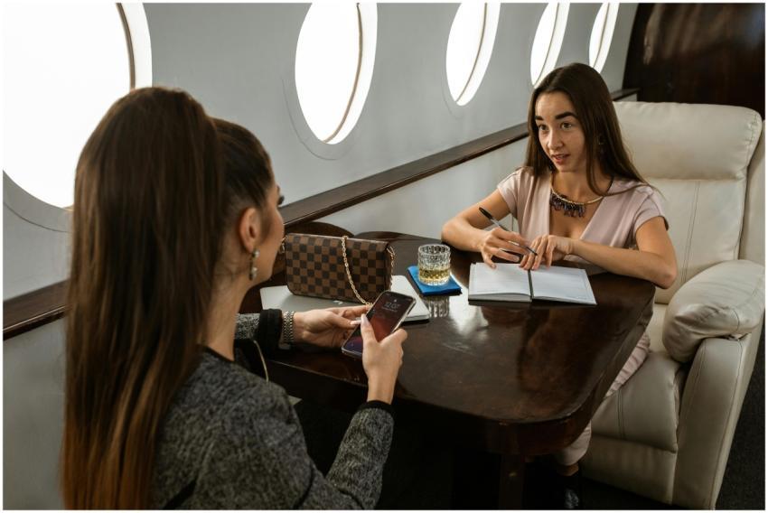 Two business women discussing work on a luxury pri